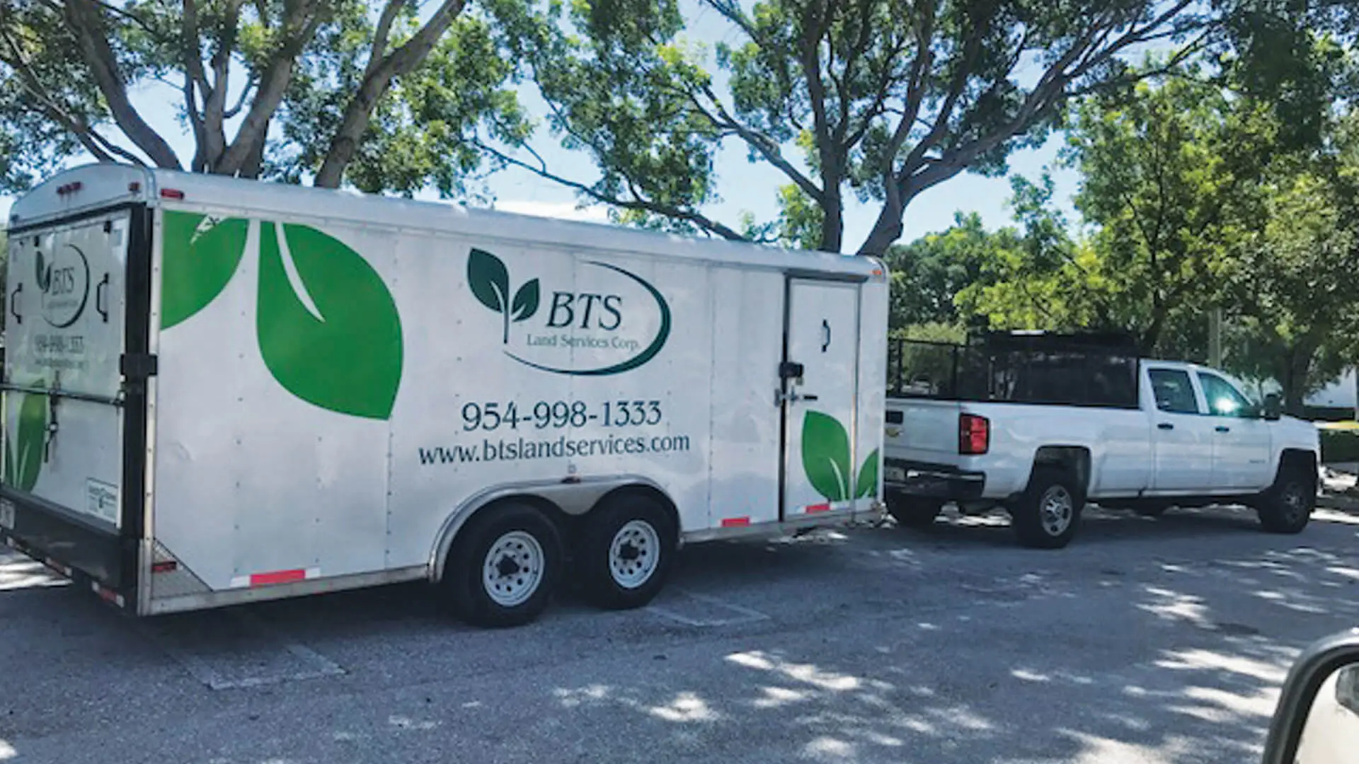 BTS Land Services Corp truck and trailer for commercial lawn and landscaping services.
