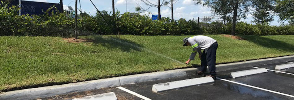 Our irrigation specialist adjusting a sprinkler head at business in Davie, FL.